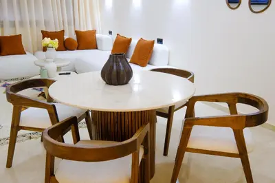 a table and chairs in a living room with a couch at Appartement vacances famille Marrakech in Marrakech