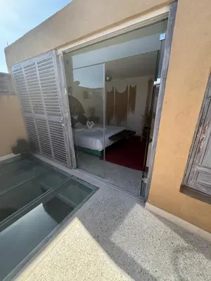 a view of a bedroom through a sliding glass door at Riad Mtiwel in Marrakech