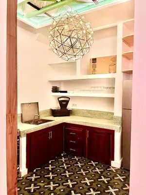 a kitchen with a counter with a laptop and a chandelier at Riad Mtiwel in Marrakech