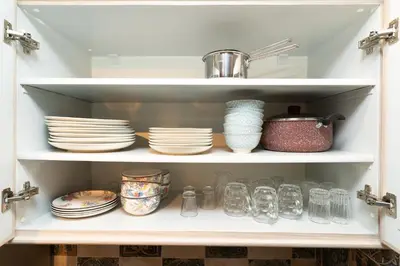 a cabinet filled with plates and bowls and dishes at Gueliz Stay in Marrakech