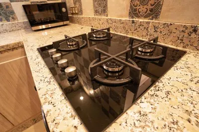 a black stove top oven in a kitchen at Gueliz Stay in Marrakech