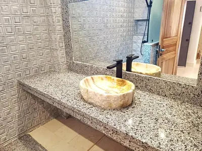 a bathroom with a wooden sink and a mirror at Gueliz Stay in Marrakech