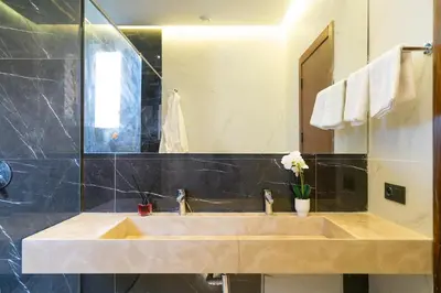 a bathroom with a sink and a mirror at Luxury Villa with Breakfast & Padel Access in Marrakech