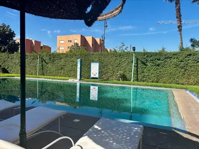 a swimming pool in a house with a fence at Cozy 2-bedroom apartment & pool & wifi in Marrakech