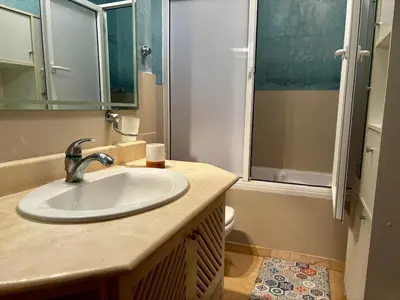 a bathroom with a sink and a shower at Cozy 2-bedroom apartment & pool & wifi in Marrakech