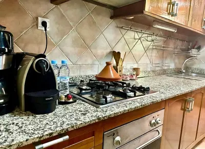 a kitchen with a stove with a tea kettle on it at Cozy 2-bedroom apartment & pool & wifi in Marrakech