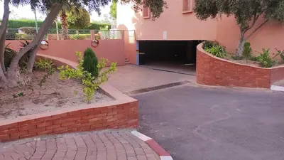 a building with a driveway and a brick wall at Cozy 2-bedroom apartment & pool & wifi in Marrakech