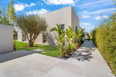 a white house with trees and a walkway at VILLA Twenty six 1600m2 Marrakech LUXE & PROXIMITÉ in Marrakech
