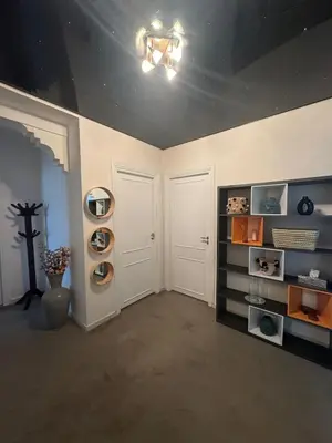 a room with two white doors and shelves at Élégant et calme, à 2 minutes des meilleurs restaurants in Marrakech