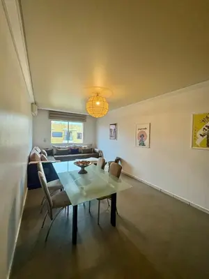 a dining room with a table and chairs at Élégant et calme, à 2 minutes des meilleurs restaurants in Marrakech