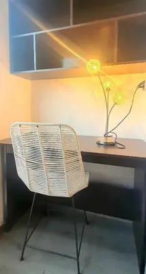 a desk with a lamp and a plant on it at Élégant et calme, à 2 minutes des meilleurs restaurants in Marrakech