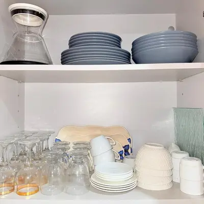 a shelf filled with plates and bowls and dishes at Chic Stay in Gueliz 4 Free Parking Netflix in Marrakech