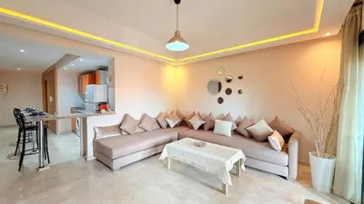 a living room with a couch and a table at Chic Stay in Gueliz 4 Free Parking Netflix in Marrakech