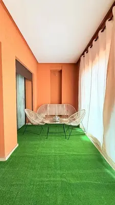 a room with a table and chairs on a green floor at Chic Stay in Gueliz 4 Free Parking Netflix in Marrakech
