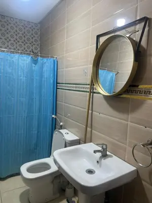 a bathroom with a toilet and a sink and a mirror at modern apartment, 10 minutes from the airport in Oulad Akkou