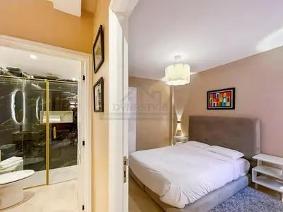 a bedroom with a white bed and a bathroom at Appartement neuf et chic Proche gare et CTM in Marrakech