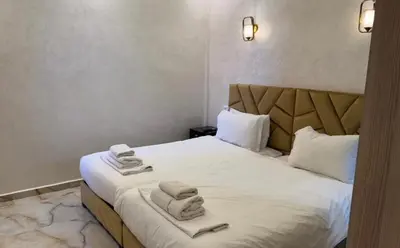 a hotel room with a bed with towels on it at Appartement cozy in Marrakech