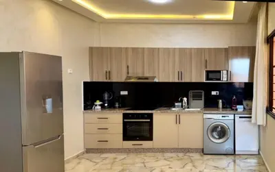 a kitchen with a washer and a dishwasher at Appartement cozy in Marrakech
