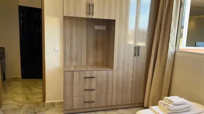 a wooden cabinet in a bathroom with a mirror at Appartement cozy in Marrakech