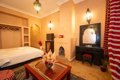 a hotel room with a bed and a fireplace at Mumtaz Dar in Marrakech