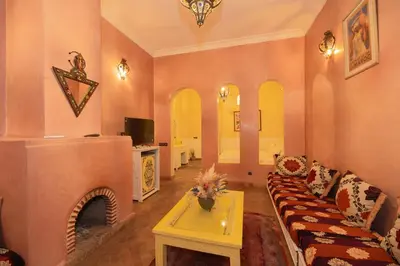 a living room with a couch and a fireplace at Mumtaz Dar in Marrakech