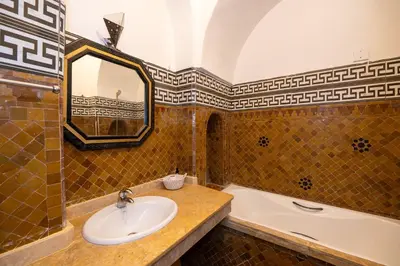 a bathroom with a sink and a bath tub at Mumtaz Dar in Marrakech