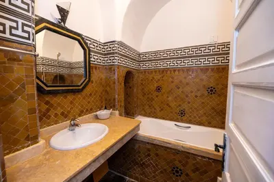a bathroom with a sink and a tub at Mumtaz Dar in Marrakech