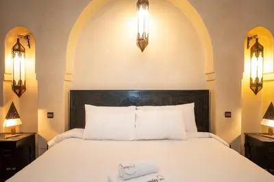 a bedroom with a bed with two towels on it at Mumtaz Dar in Marrakech