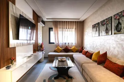 a living room with a couch and a table at Oasis Urban & Balcon - 5 min de l'aeroport in Marrakech