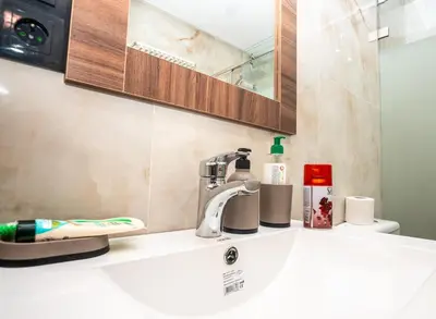 a bathroom sink with a faucet and a mirror at Oasis Urban & Balcon - 5 min de l'aeroport in Marrakech