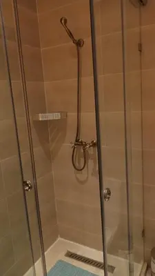 a shower stall with a glass shower door at Your chic retreat under the Marrakesh sun in Marrakech