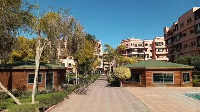 a brick walkway in a city with buildings at Your chic retreat under the Marrakesh sun in Marrakech