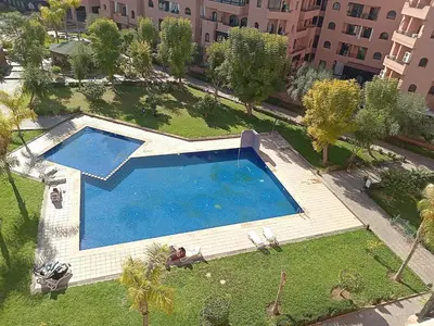 an overhead view of a large swimming pool in a city at Your chic retreat under the Marrakesh sun in Marrakech