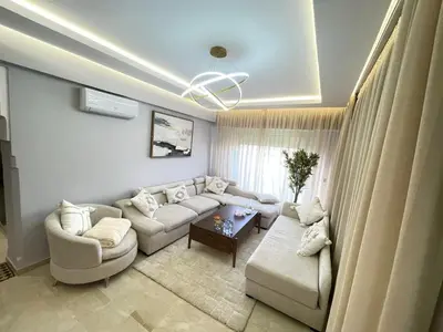 a living room with a couch and a table at nice apartment, Luxury Wintering, Caprice Palace in Marrakech
