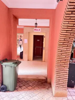 an entrance to a building with a trash can in a hallway at nice apartment, Luxury Wintering, Caprice Palace in Marrakech