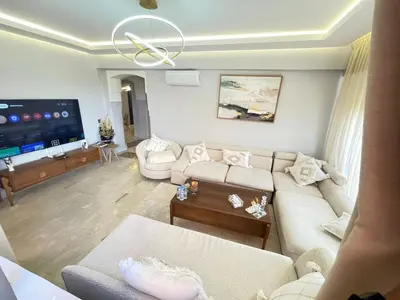 a living room with a couch and a flat screen tv at nice apartment, Luxury Wintering, Caprice Palace in Marrakech