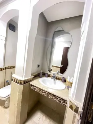 a bathroom with a sink and a mirror at nice apartment, Luxury Wintering, Caprice Palace in Marrakech