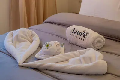 a couple of towels on top of a couch at 2 King Suites 2 Living Rooms 3 min Gueliz Carre Eden in Marrakech
