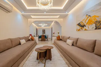 a living room with a couch and a table at 2 King Suites 2 Living Rooms 3 min Gueliz Carre Eden in Marrakech