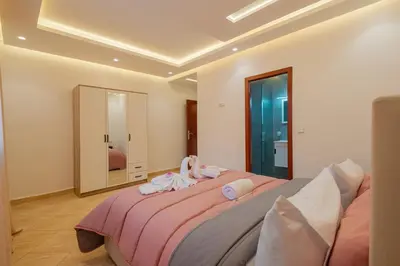 a bedroom with a large bed with towels on it at 2 King Suites 2 Living Rooms 3 min Gueliz Carre Eden in Marrakech