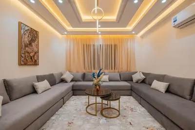 a living room with a couch and a table at 2 King Suites 2 Living Rooms 3 min Gueliz Carre Eden in Marrakech