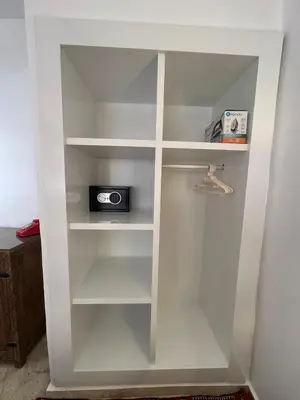 a white book shelf with a radio in it at Hébergement Moderne avec Esprit Riad a l'Hivernage in Marrakech