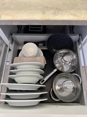 a drawer filled with plates and pans and dishes at Hébergement Moderne avec Esprit Riad a l'Hivernage in Marrakech