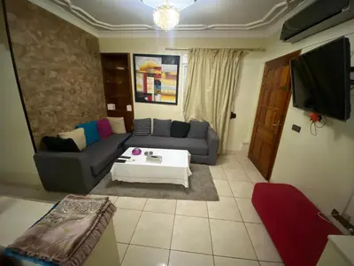 a living room with a couch and a table at Appartement Nomade in Marrakech