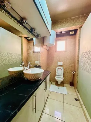 a bathroom with a sink and a toilet at Appartement Nomade in Marrakech