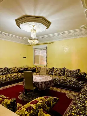 a living room with a couch and a table at Appartement Nomade in Marrakech