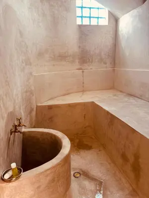 a bathroom with a large tub and a sink at Riad l'Oasis Bleue en privatisation 10 pers 3 jours mini in Marrakech