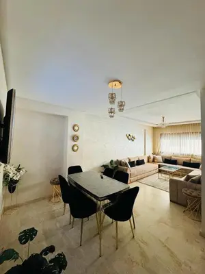 a living room with a table and a couch at Elegant City Apartment in Marrakech