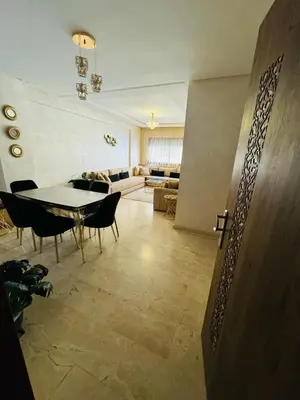 a living room with a table and chairs and a couch at Elegant City Apartment in Marrakech