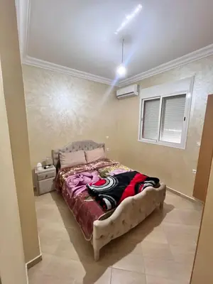a bedroom with a large bed in a room at Apartmen rentals with M Z in Oulad Akkou